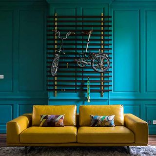 teal living room with yellow sofa