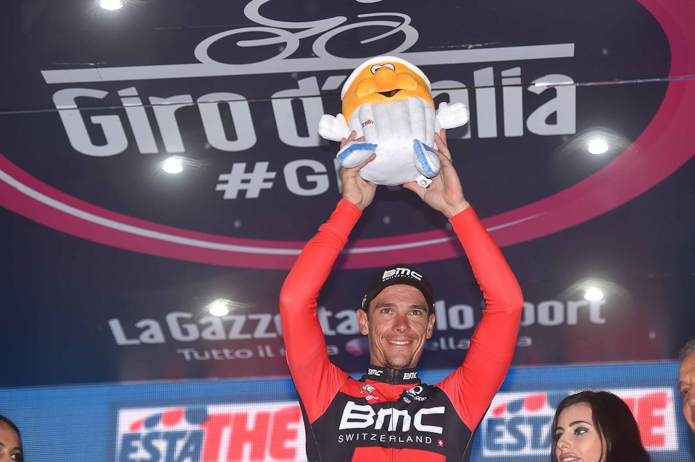 Gilbert hoists his stage trophy on the podium.
