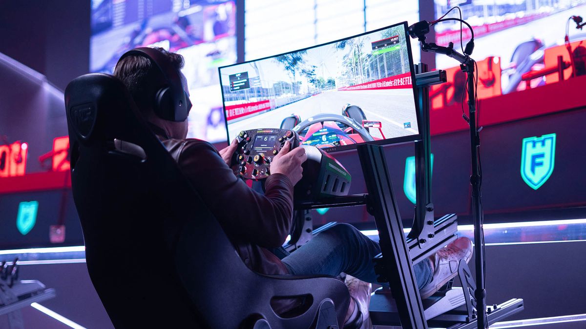 A esports gamer sits with a remote control in a car using a Marshall POV camera. 