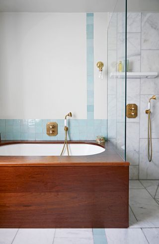 Bathroom with a reclaimed iroko wood bath surround