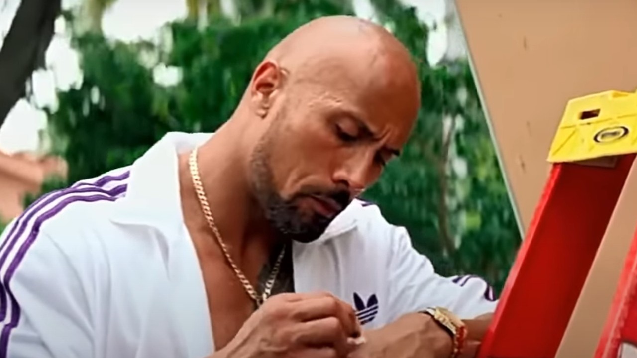 Dwayne Johnson standing by a ladder in Pain &amp;amp; Gain
