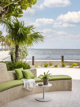 sitting outside looking at the sea at The Fairchild Coconut Grove Miami housing by Strang Design and Rafael de Cárdenas