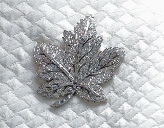 Queen Elizabeth II (maple leaf diamond brooch detail) visits Canada House to celebrate Canada's 150th anniversary of Confederation on July 19, 2017