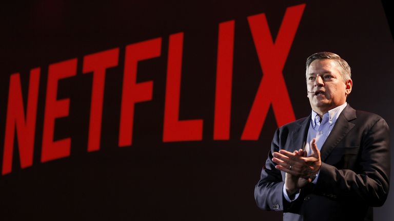 Ted Sarandos infront of Netflix logo