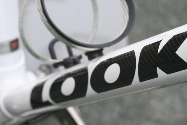 The downtube varies in shape and diameter along its length.