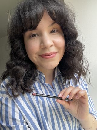 Mica holding the NYX Professional Makeup Lip Pencil in Natural
