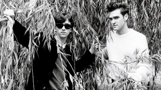 Johnny Marr (left) and Morrissey from The Smiths pose under the branches of a willow tree in London in 1983.