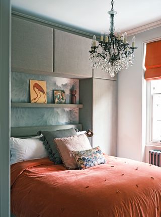 small bedroom with handleless storage above the bed