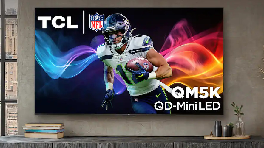 The TCL QM5K on a wall in a living room.