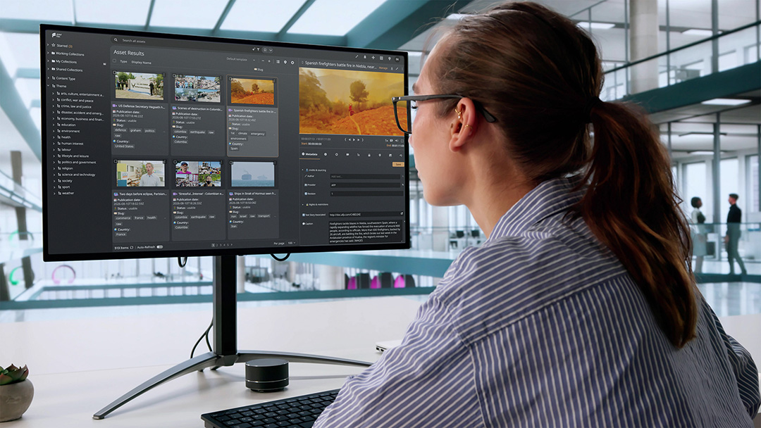 Woman looking at a computer screen while editing video