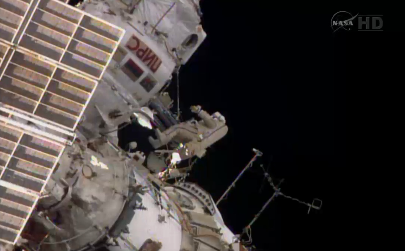 A spacewalking cosmonaut outside the station.