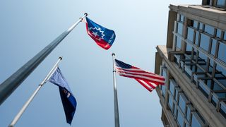 the juneteenth flag, the u.s. flag and one other flag wave outside nasa headquarters in washington, d.c.