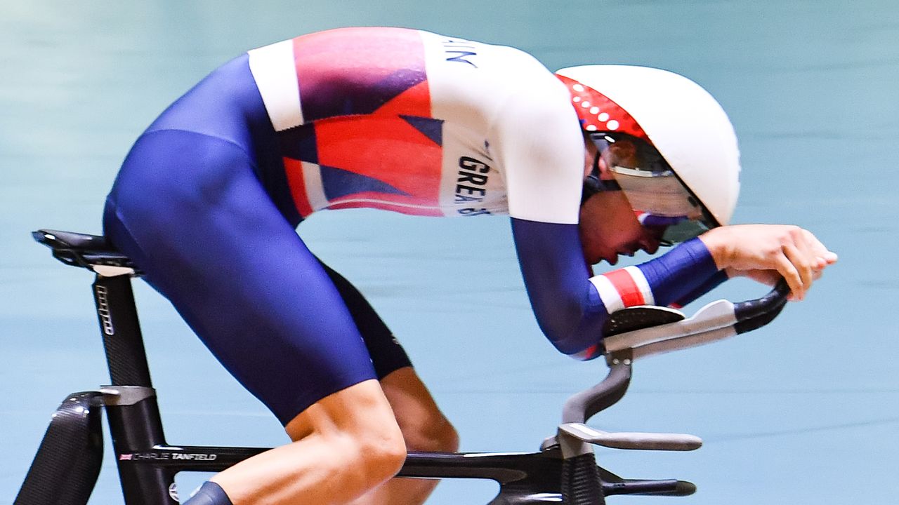 Rider on a pursuit track bike in an aero position