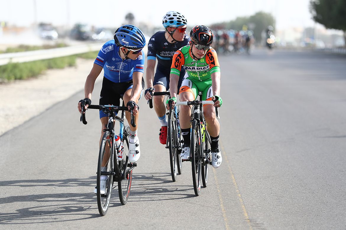 The breakaway look over their shoulders as they sense the peloton behind