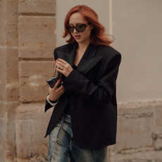 woman wearing a black blazer, oversized sunglasses in Paris 