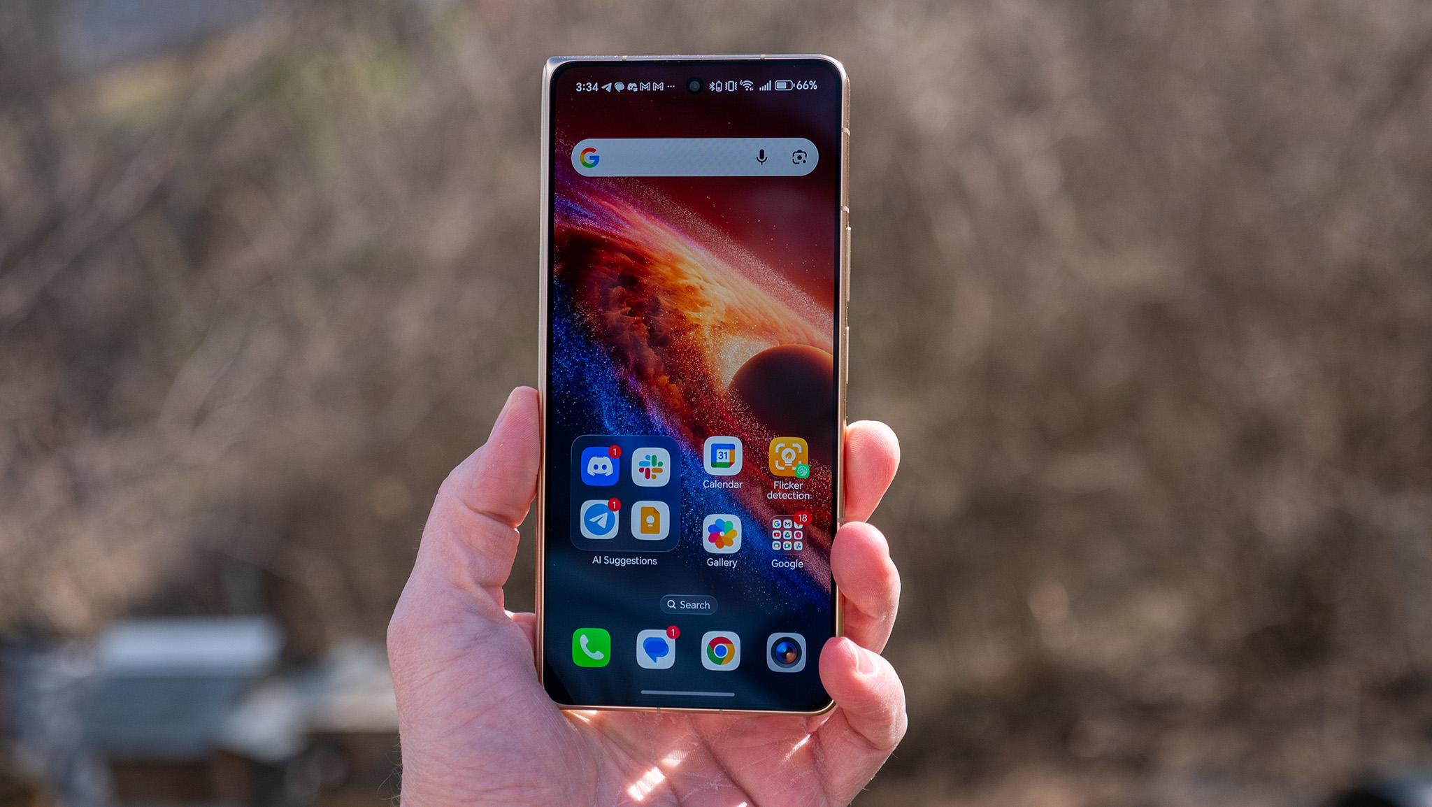 Holding the gold Honor Magic V6 and looking at its new anti-reflective front screen