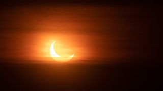 Partial solar eclipse at sunset,Montreal,Canada, the sun appears as a crescent.