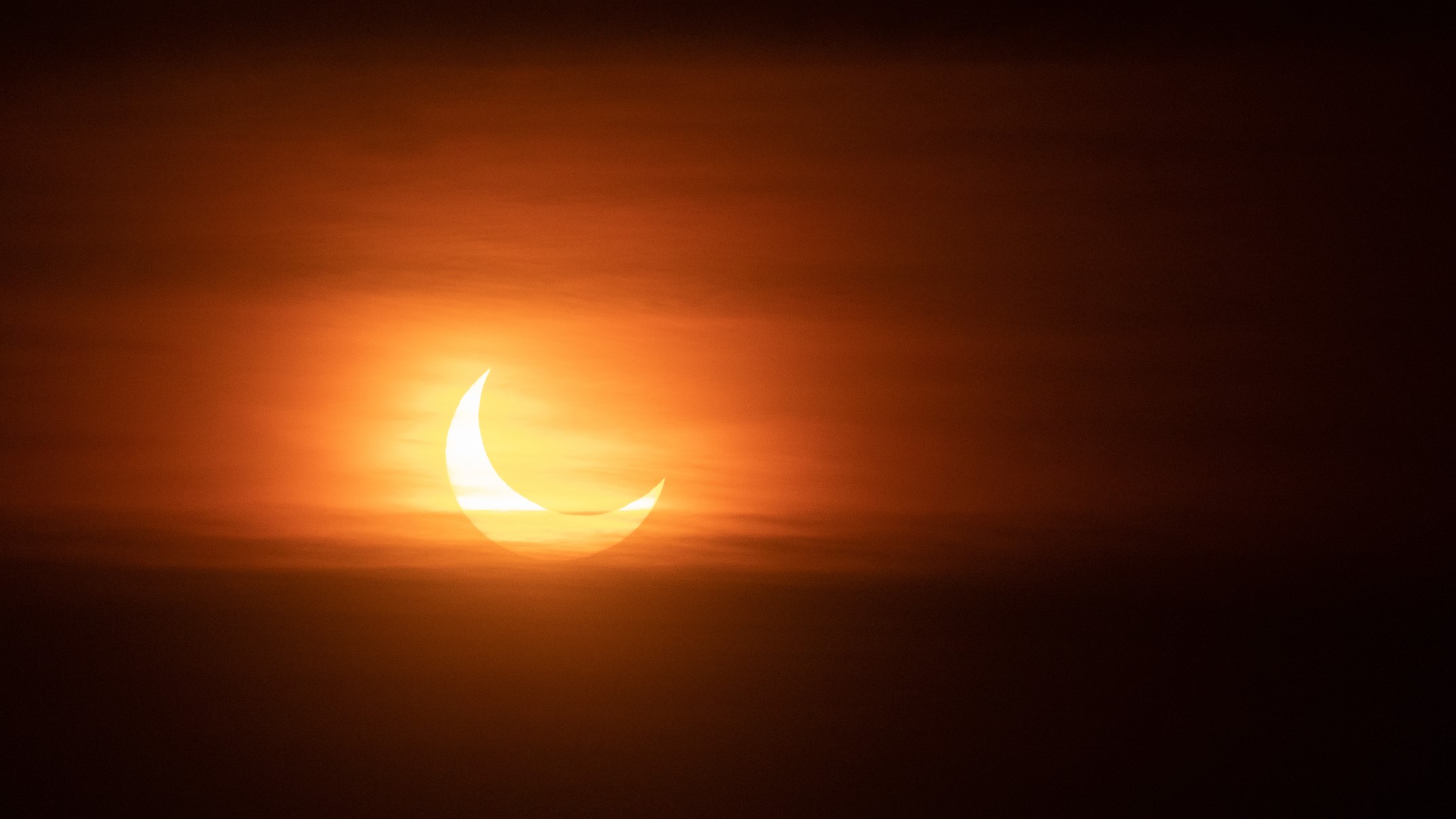 Partial solar eclipse at sunset,Montreal,Canada, the sun appears as a crescent.