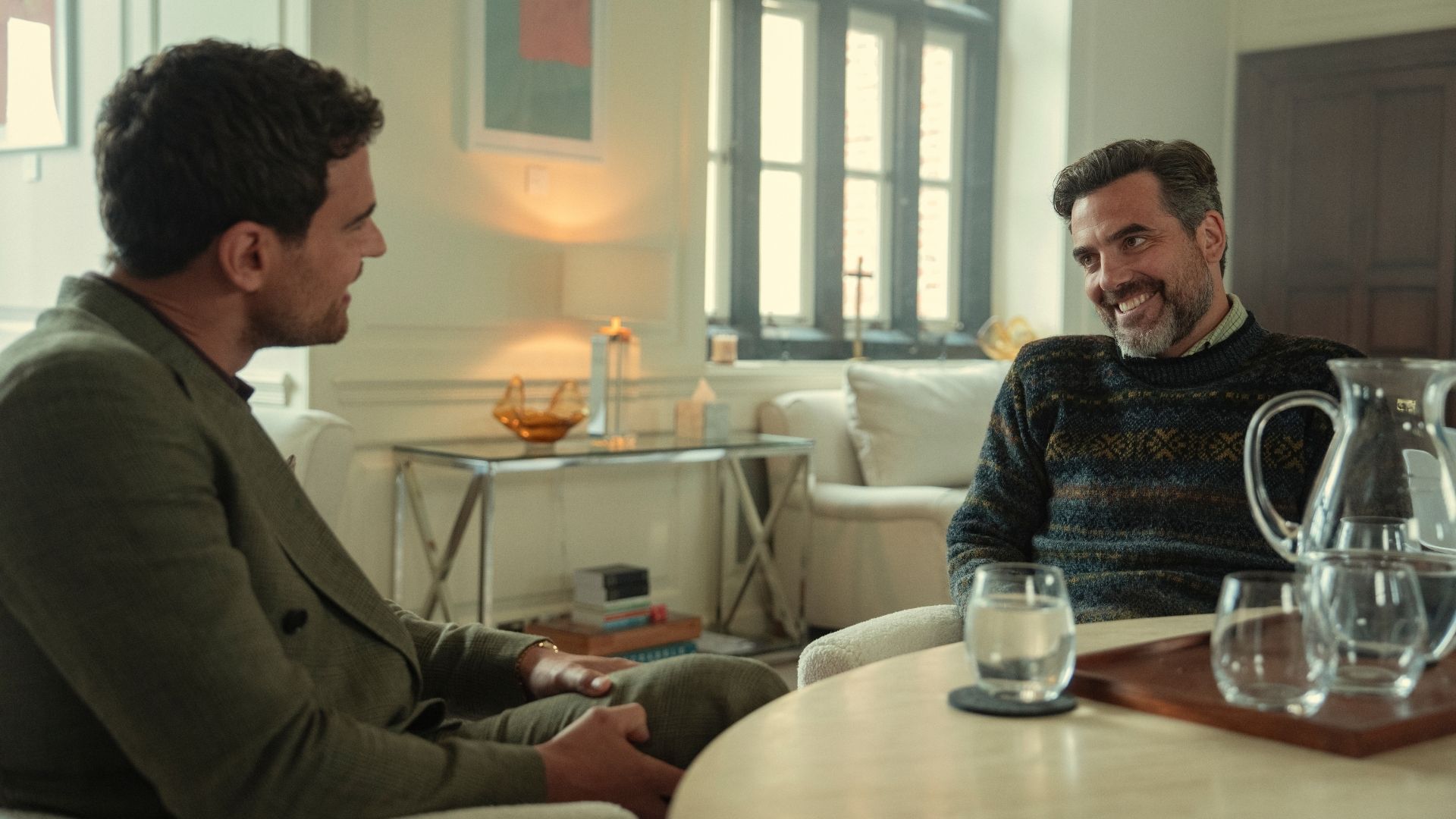 Eddie and Freddie talk to each other at a small table