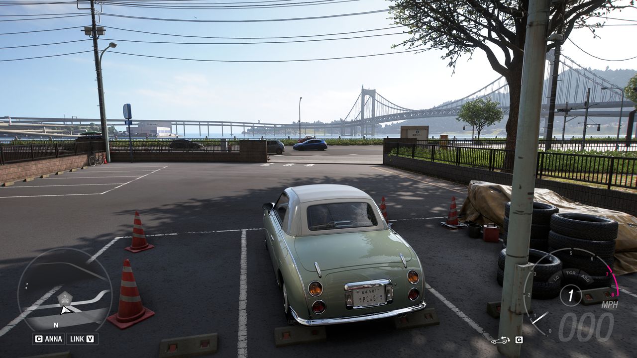 Forza Horizon 6 Treasure Cars: A Nissan Figaro parked on the coast, opposite a large bridge.