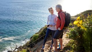 Older couple hiking along cliff