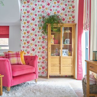 living room with pink grapefruit and mango colour palette dahlia print and armchair with cushions