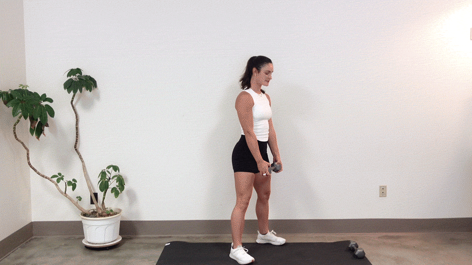trainer Kirra Mitlo doing a dumbbell wide stance squat