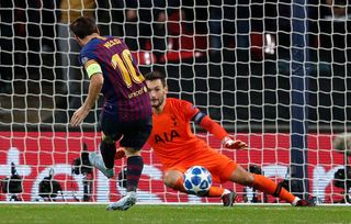 Barcelona's Argentinian striker Lionel Messi (L) scores his team's fourth, and his second goal past Tottenham Hotspur's French goalkeeper Hugo Lloris during the Champions League group B football match match between Tottenham Hotspur and Barcelona at Wembley Stadium in London, on October 3, 2018.