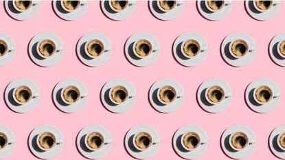 Pattern made of cup of fresh coffee on pastel pink color background. Directly above view of fresh coffee in white cups. 