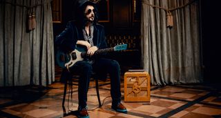 Mike Campbell of the Dirty Knobs, in hat, shades, guitar in hand