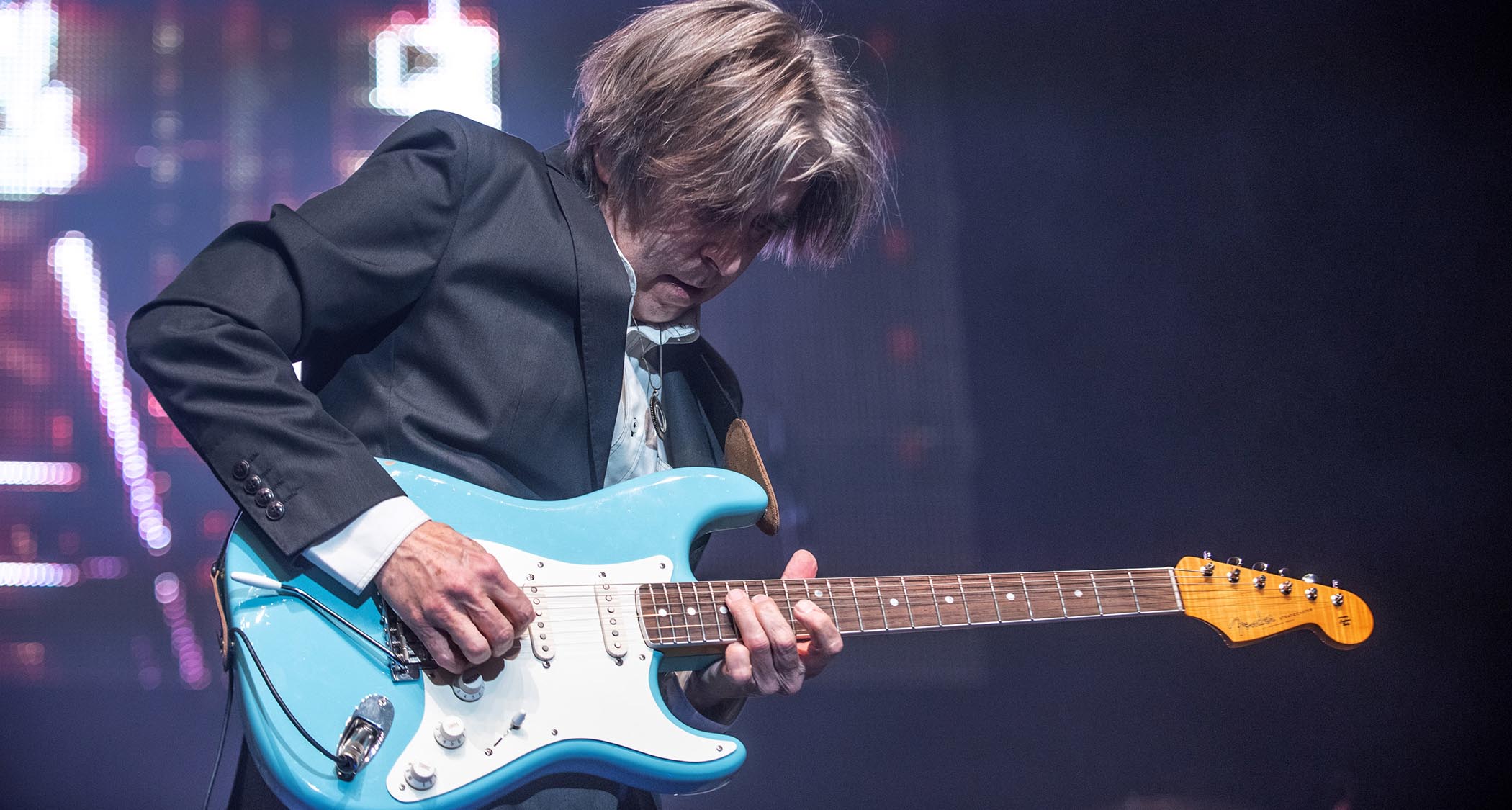 Eric Johnson rips a solo on his signature Strat onstage in 2019.