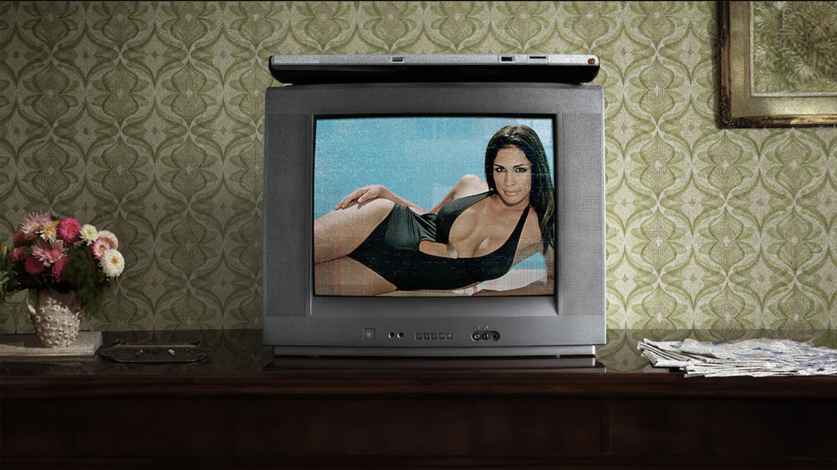 An old-fashioned silver TV on a brown table shows Miriam Rivera posing in a black bikini for Miriam: Death of a Reality Star