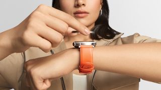 The Nothing CMF Watch Pro 2 with a person lifting its bezel off