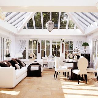 conservatory with sofa cushions and round table and chairs