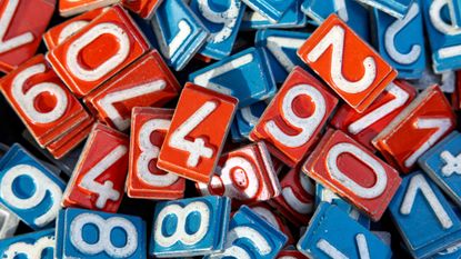 A close-up view of red and blue metal number tiles