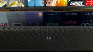 Close up of Sony soundbar in front of a TV screen