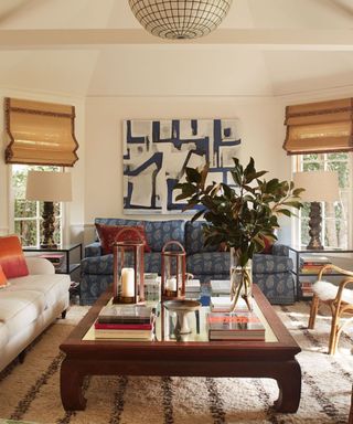 neutral sunroom with chik blinds and red white and blue traditional vintage decor and large artwork