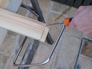 a hacksaw cutting a skirting board