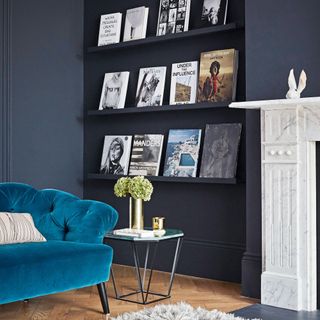 Family room corner with turquoise blue chesterfield, brass side table and a bookcase