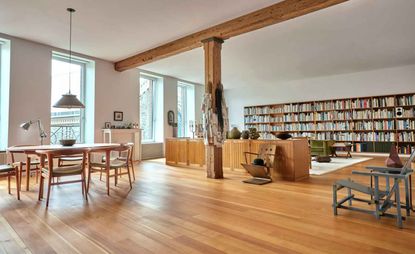 New York loft interior with wide bookcase and mid-century furniture collected by Michael Maharam