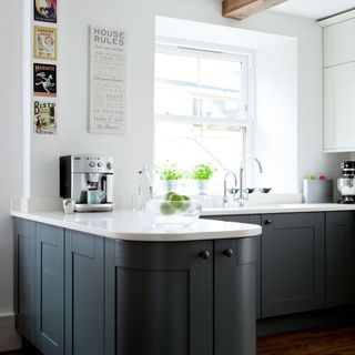 kitchen with white walls grey walls and wooden flooring