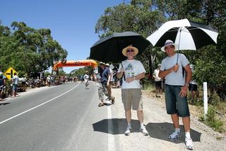 Fans used umbrellas to shelter from the blistering sun