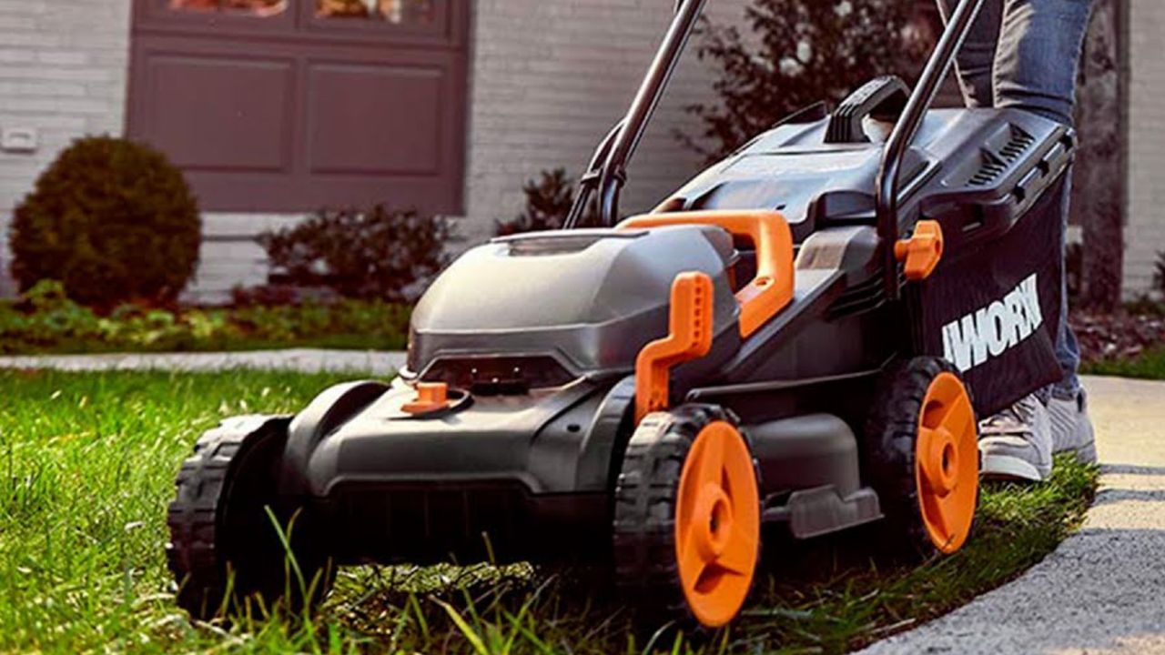 The Worx WG779E.2 40V Cordless Lawn Mower mowing grass in a front yard