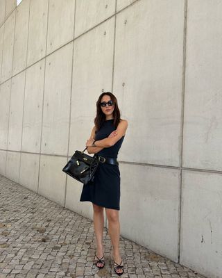 @deborabrosa wearing an LBD, strappy heels and a handbag