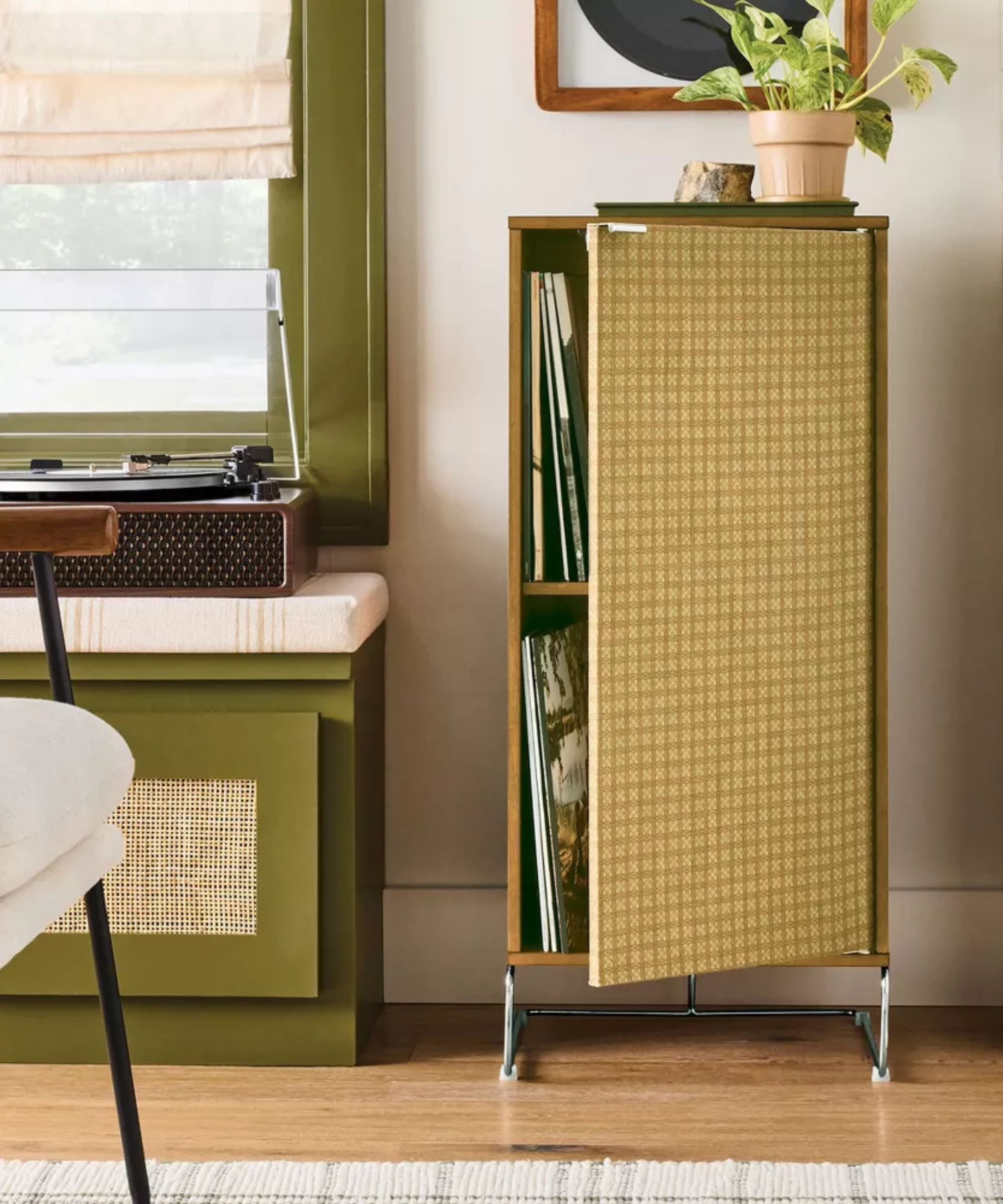a mid-century style storage cabinet with a fabric door
