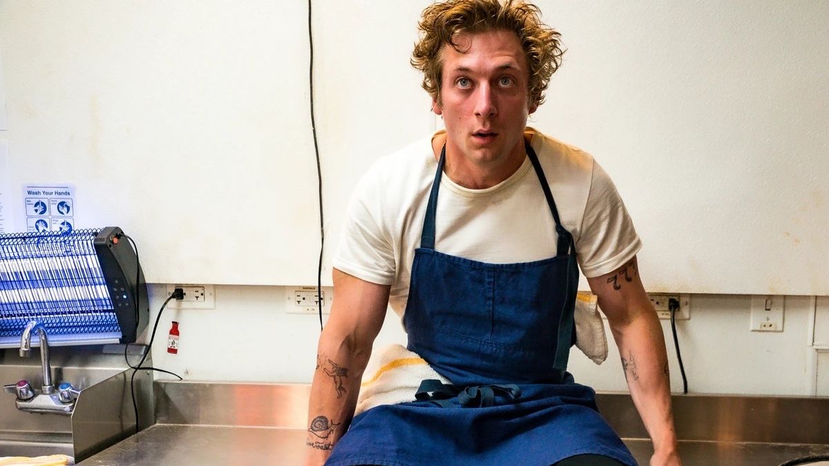 Jeremy Allen White as Carmy sitting in the kitchen on The Bear