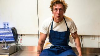 Jeremy Allen White as Carmy sitting in the kitchen on The Bear