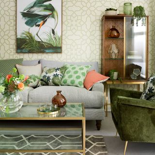 A living room with a grey sofa and an olive green chair
