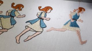 Close up of peasant girl run cycle being embroidered