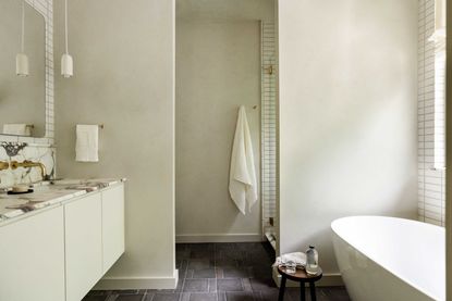 a limewash and marble bathroom